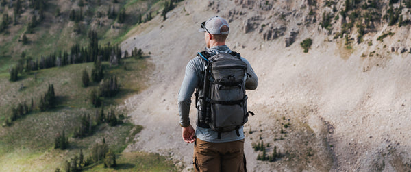 Hunter in mountains with daypack
